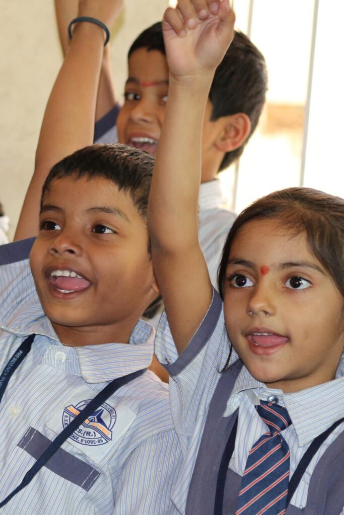 Presidency Public School students raising hands